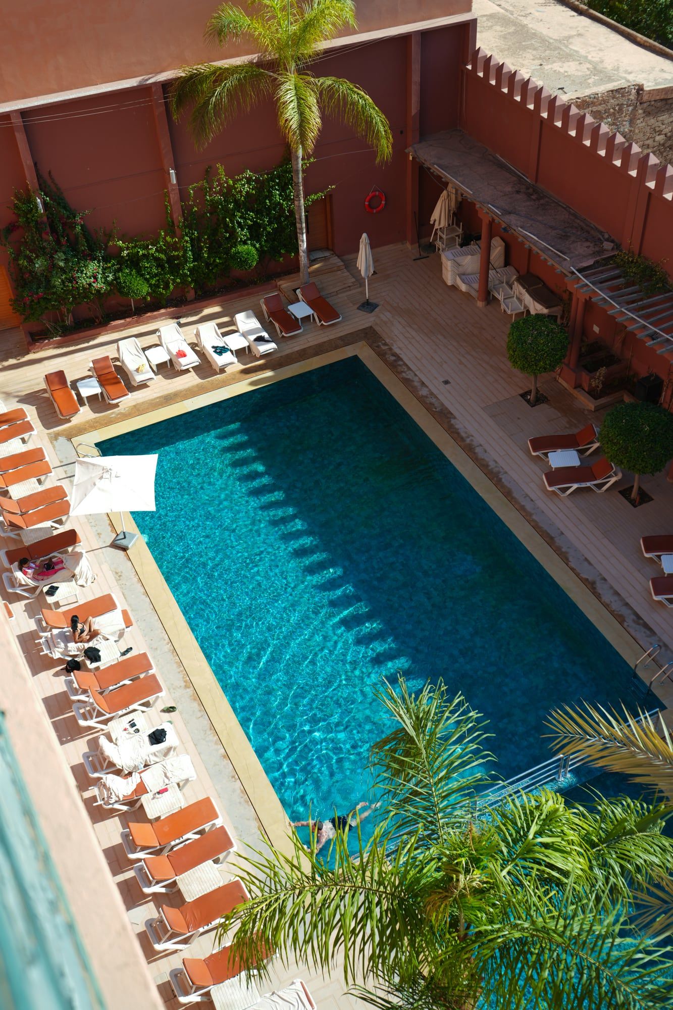 Aerial view of a pool and sun loungers in Marrakech