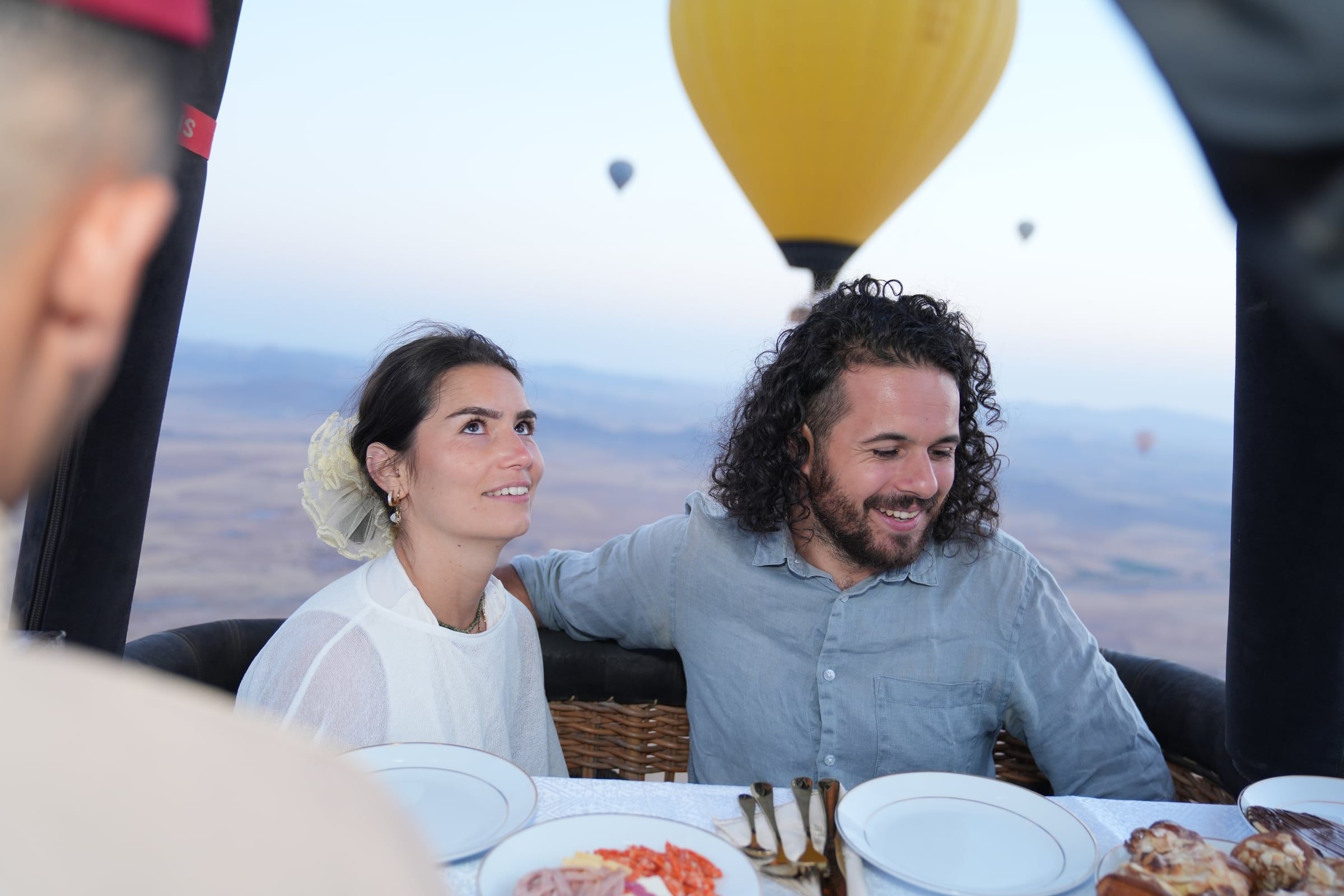 Travellers in a hot-air balloon basket above the Marrakech plains
