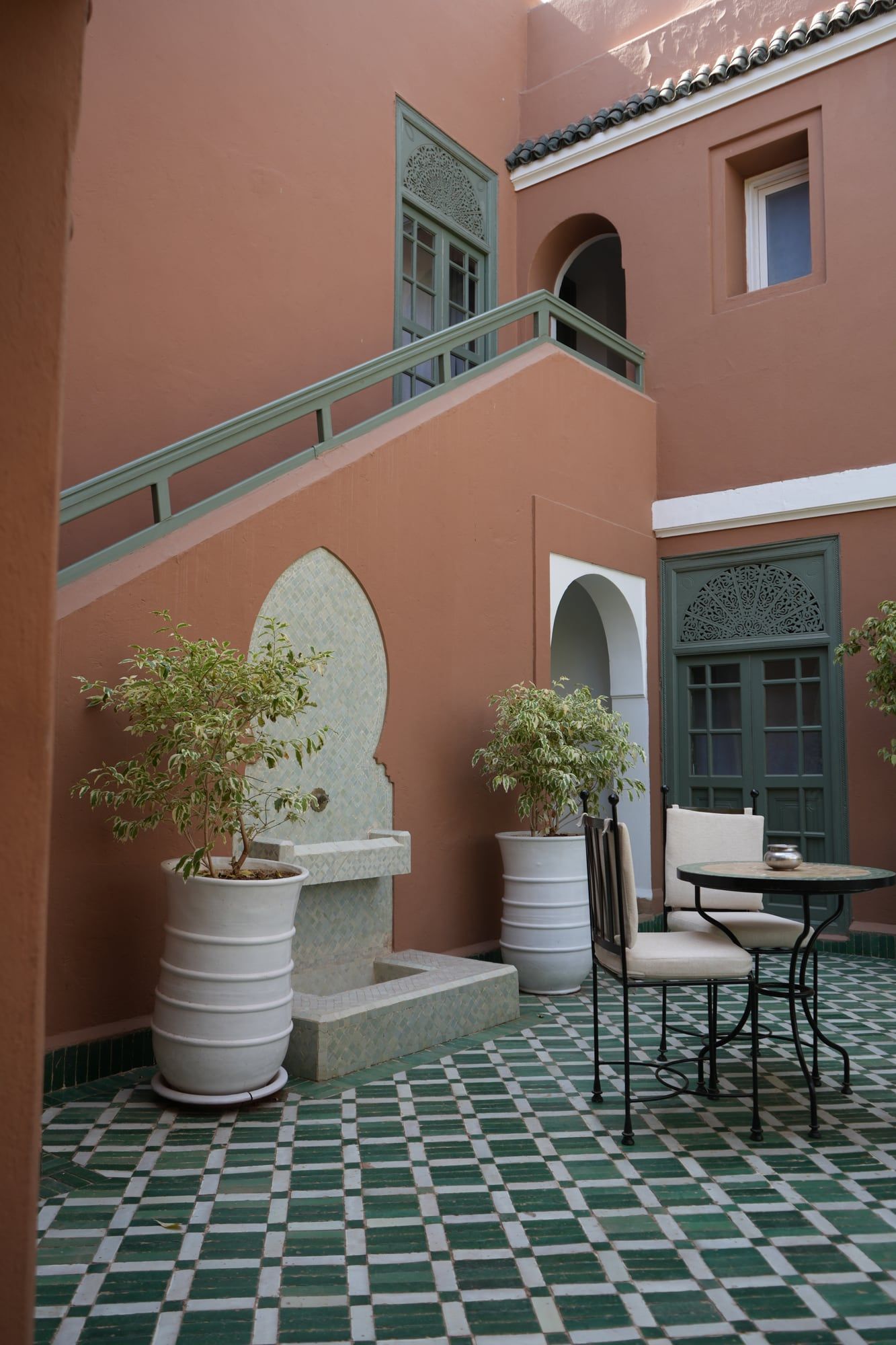 Tiled patio with white planters at Les Jardins de la Médina riad