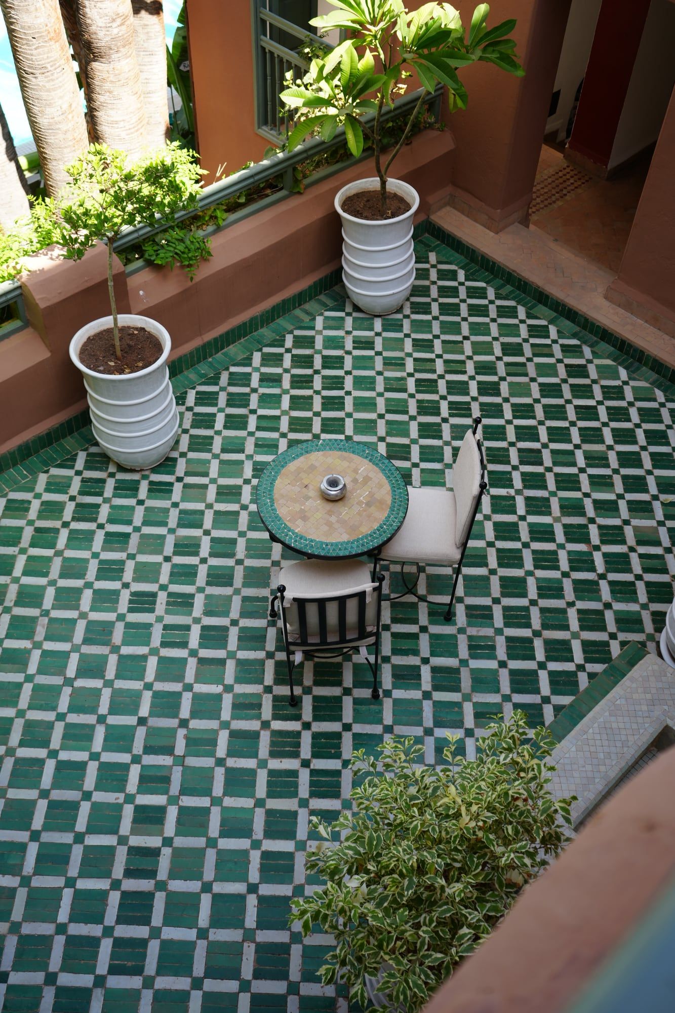 Riad terrace with a green zellige floor in Marrakech